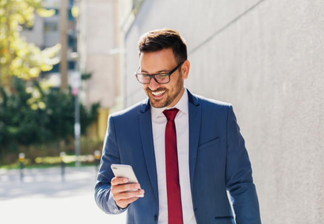 Person on their phone smiling 